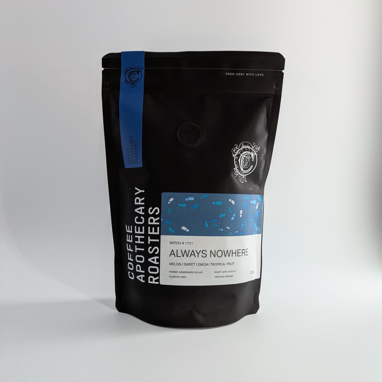 Black coffee bag with blue and white label on a light gray background